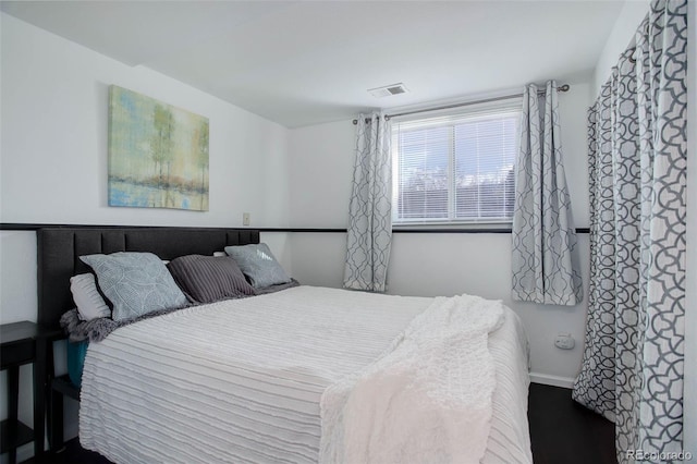 bedroom featuring visible vents and baseboards