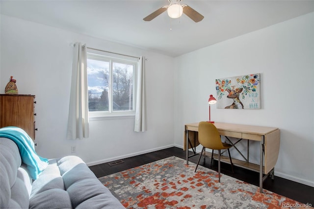 office with a ceiling fan, visible vents, baseboards, and wood finished floors