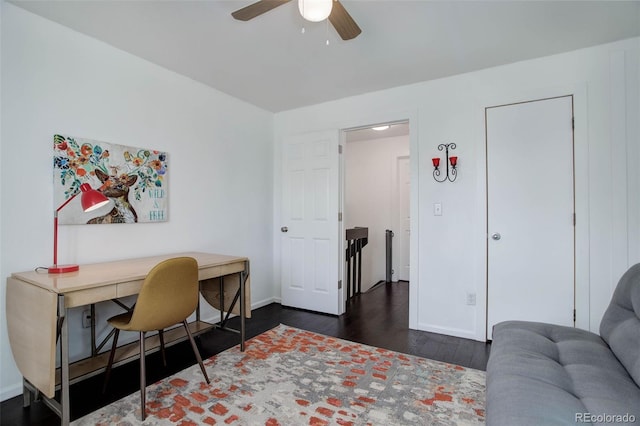 office featuring dark wood-style floors, baseboards, and a ceiling fan