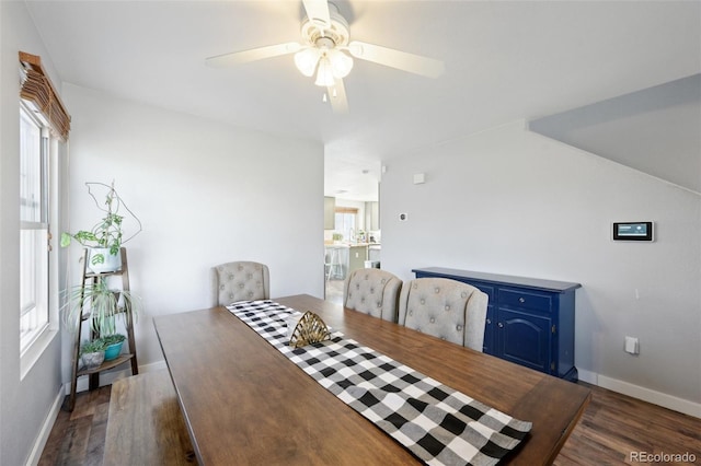 dining space with dark wood-style floors, baseboards, and a ceiling fan