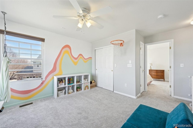 game room featuring ceiling fan, carpet, visible vents, and baseboards