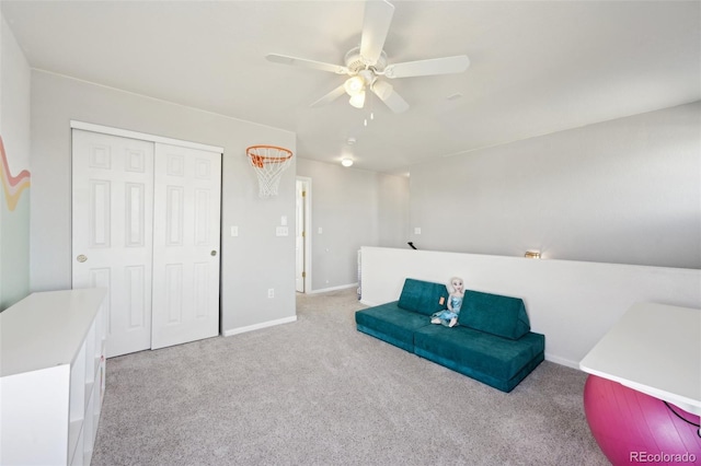 living area with a ceiling fan, carpet, and baseboards