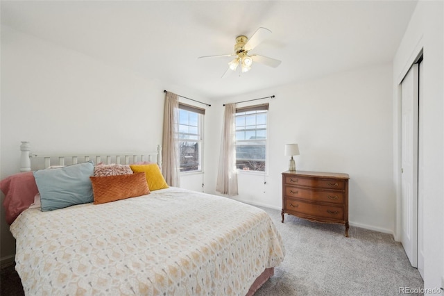 carpeted bedroom featuring baseboards, a closet, and ceiling fan