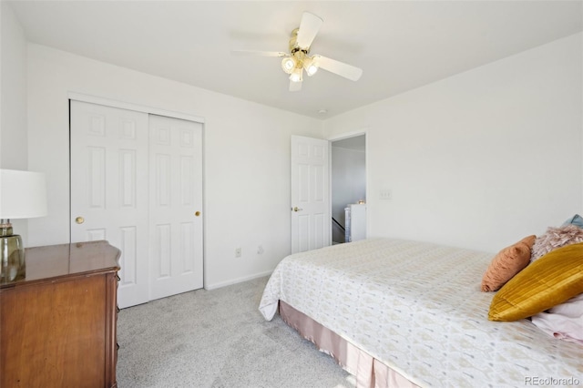 bedroom featuring a closet, light carpet, and a ceiling fan