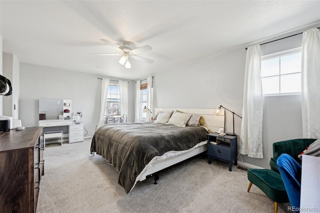 bedroom featuring ceiling fan, a textured ceiling, and carpet