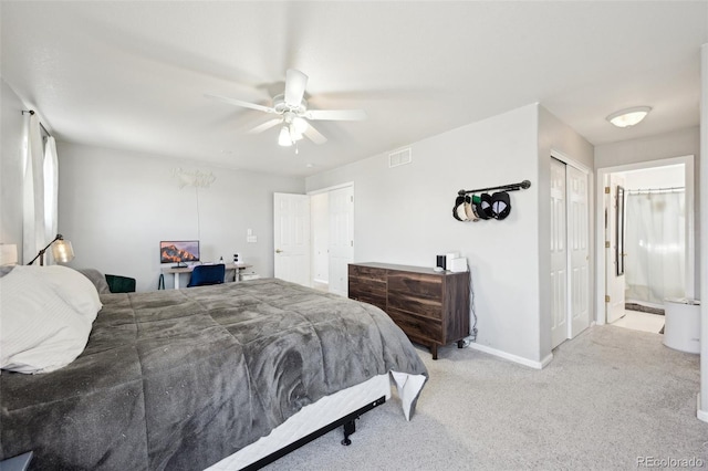 bedroom featuring visible vents, baseboards, ceiling fan, carpet flooring, and ensuite bathroom