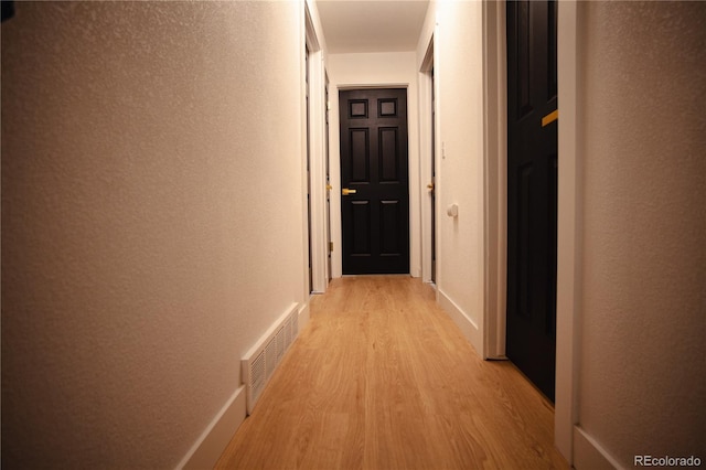 1552 S Fairplay Way, Aurora, CO 80012 - corridor with light wood-style flooring and a textured wall