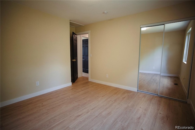 1552 S Fairplay Way, Aurora, CO 80012 - unfurnished bedroom featuring light wood-style floors and a closet