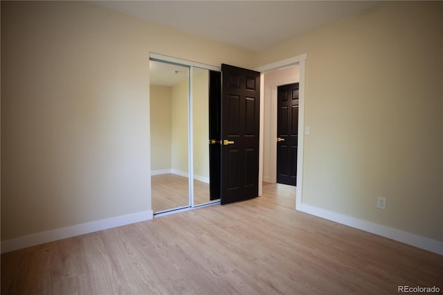 1552 S Fairplay Way, Aurora, CO 80012 - unfurnished bedroom with light wood finished floors and a closet