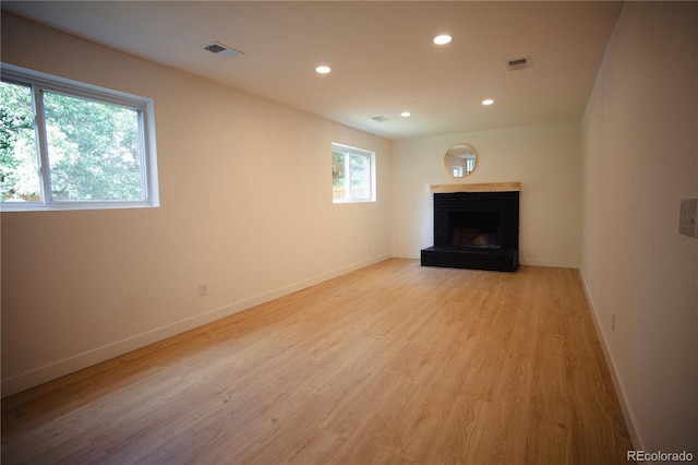 1552 S Fairplay Way, Aurora, CO 80012 - unfurnished living room featuring recessed lighting, a fireplace, and light wood finished floors