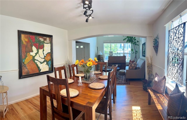 15674 Greenstone Cir, Parker, CO 80134 - dining area with arched walkways and wood finished floors