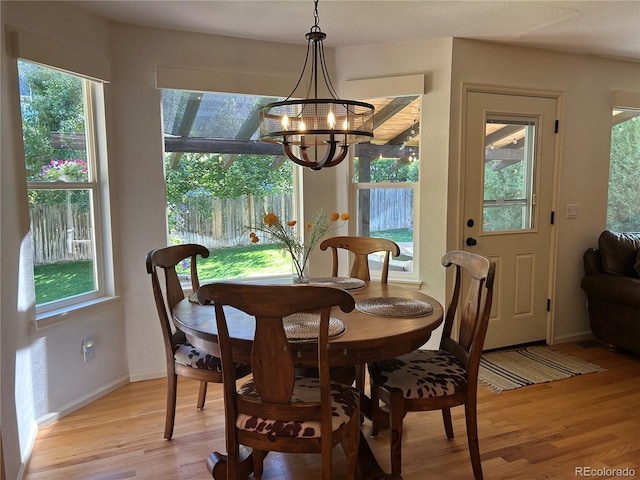 15674 Greenstone Cir, Parker, CO 80134 - dining space with light wood-style floors, a chandelier, and plenty of natural light