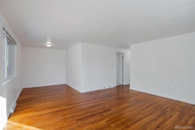 unfurnished room featuring hardwood / wood-style flooring