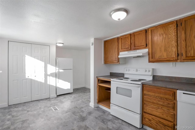 kitchen with white appliances and a textured ceiling