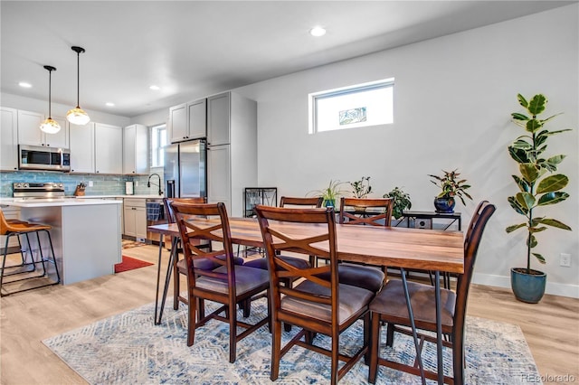 dining area featuring light wood-type flooring