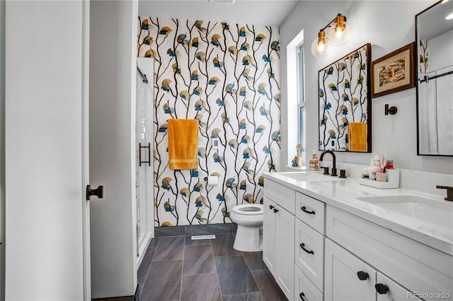 bathroom featuring tile patterned flooring, toilet, vanity, and walk in shower