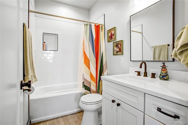 full bathroom with vanity, wood-type flooring, shower / bath combination with curtain, and toilet