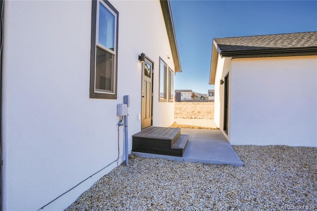 view of property exterior with a patio area