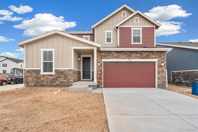 20630 E 58th Ave, Aurora, CO 80019 - craftsman-style house featuring board and batten siding, stone siding, an attached garage, and driveway