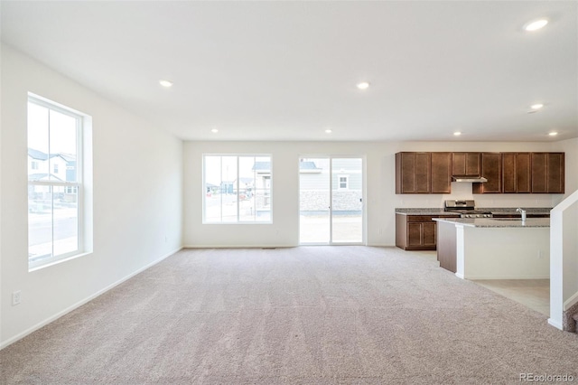 20630 E 58th Ave, Aurora, CO 80019 - kitchen with stainless steel stove, light colored carpet, recessed lighting, under cabinet range hood, and baseboards