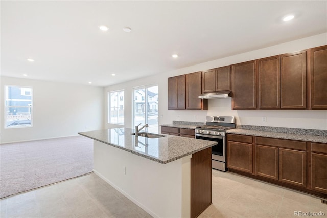 20630 E 58th Ave, Aurora, CO 80019 - kitchen with stainless steel gas range, a sink, light colored carpet, under cabinet range hood, and recessed lighting