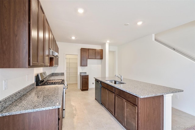 20630 E 58th Ave, Aurora, CO 80019 - kitchen featuring a sink, stainless steel range with gas cooktop, dishwasher, ventilation hood, and an island with sink