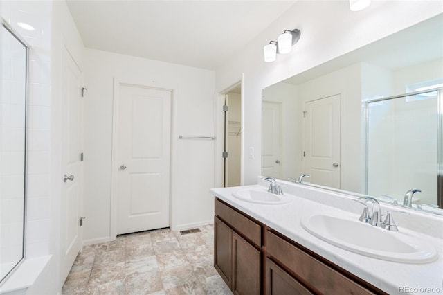 20630 E 58th Ave, Aurora, CO 80019 - full bath featuring a stall shower, baseboards, double vanity, and a walk in closet