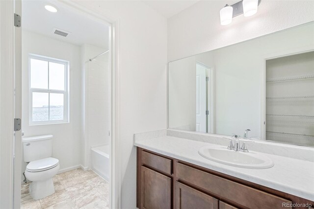20630 E 58th Ave, Aurora, CO 80019 - bathroom featuring toilet, vanity, baseboards, and shower / bathtub combination