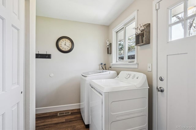 washroom featuring laundry area, dark wood-style flooring, visible vents, baseboards, and washer and clothes dryer
