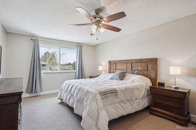 bedroom with carpet floors, baseboards, a ceiling fan, and a textured ceiling
