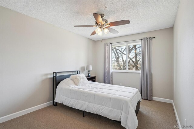 carpeted bedroom with a ceiling fan, a textured ceiling, and baseboards