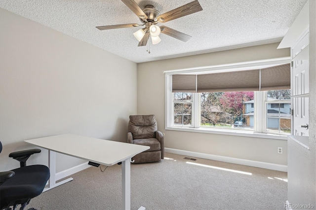 office with ceiling fan, a textured ceiling, visible vents, baseboards, and carpet floors