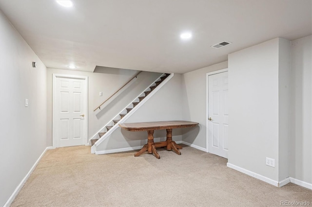 finished below grade area with baseboards, carpet, stairs, and visible vents