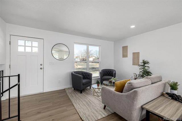 living area featuring recessed lighting, wood finished floors, and baseboards