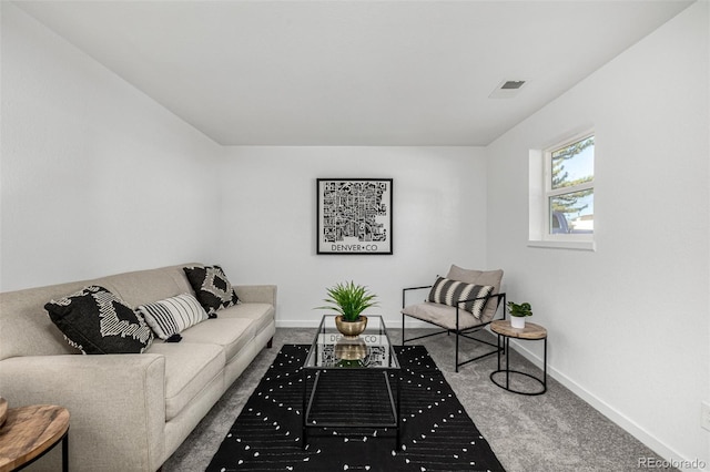 living room featuring carpet flooring, visible vents, and baseboards