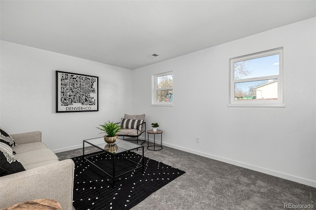 carpeted living room with visible vents and baseboards