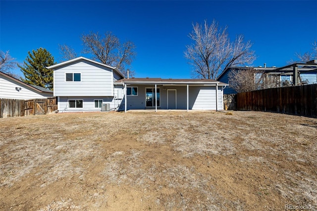 back of property featuring central air condition unit and a fenced backyard