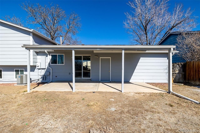 back of property with central AC unit, a patio area, and fence