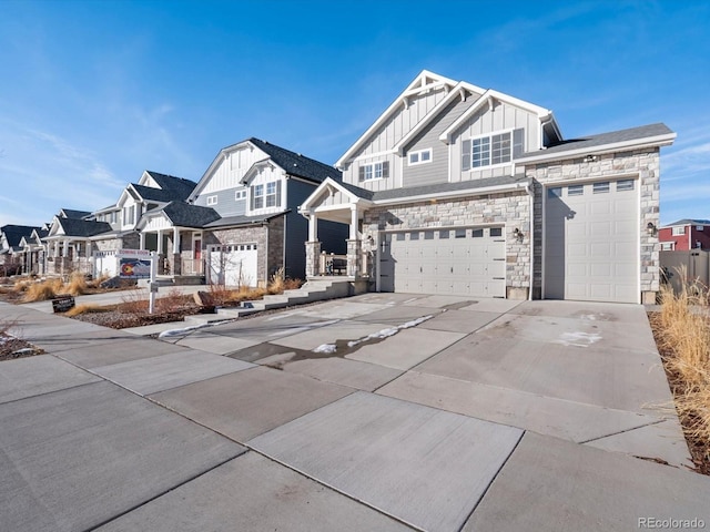 21901 E 42nd Pl, Aurora, CO 80019 - view of front facade with board and batten siding, stone siding, driveway, a residential view, and a garage