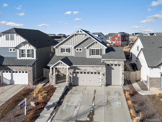 21901 E 42nd Pl, Aurora, CO 80019 - view of front of property with board and batten siding, a residential view, driveway, an attached garage, and fence