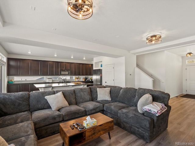 21901 E 42nd Pl, Aurora, CO 80019 - living area featuring light wood finished floors, stairway, and recessed lighting