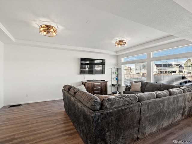 21901 E 42nd Pl, Aurora, CO 80019 - living area featuring a raised ceiling, wood finished floors, and baseboards