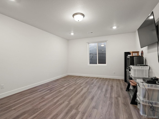 21901 E 42nd Pl, Aurora, CO 80019 - unfurnished living room featuring wood finished floors, baseboards, and recessed lighting