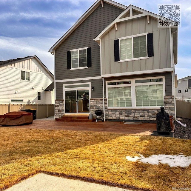 21901 E 42nd Pl, Aurora, CO 80019 - rear view of house featuring board and batten siding, a patio, stone siding, and a hot tub