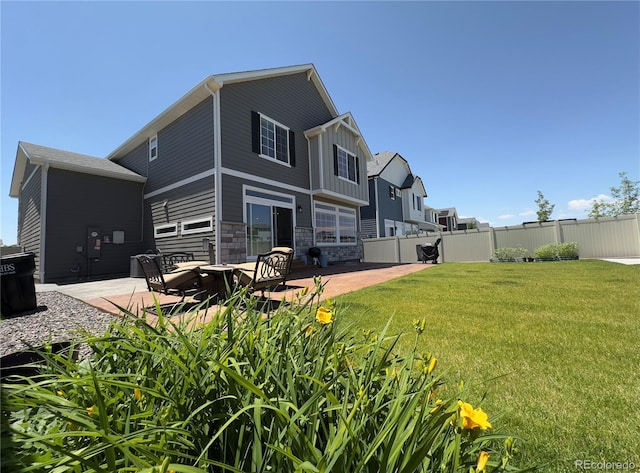 21901 E 42nd Pl, Aurora, CO 80019 - back of property featuring a patio area, stone siding, and board and batten siding