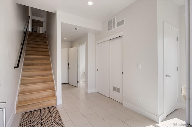 entrance foyer featuring stairs, recessed lighting, baseboards, and light tile patterned floors