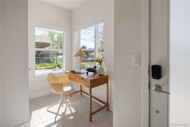 home office featuring baseboards and light tile patterned floors