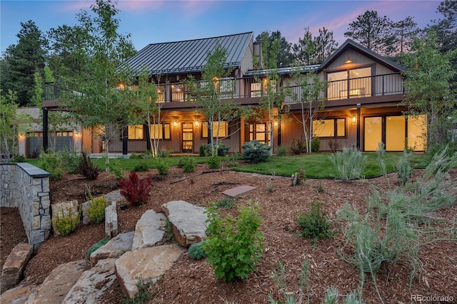 1298 Meadow View Dr, Evergreen, CO 80439 - back of house with a standing seam roof, a deck, and a metal roof