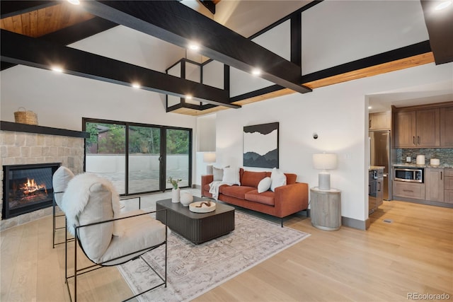 1298 Meadow View Dr, Evergreen, CO 80439 - living area with high vaulted ceiling, light wood-style flooring, a fireplace, and beam ceiling
