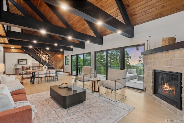 1298 Meadow View Dr, Evergreen, CO 80439 - living area featuring wooden ceiling, wood finished floors, a fireplace, and stairs